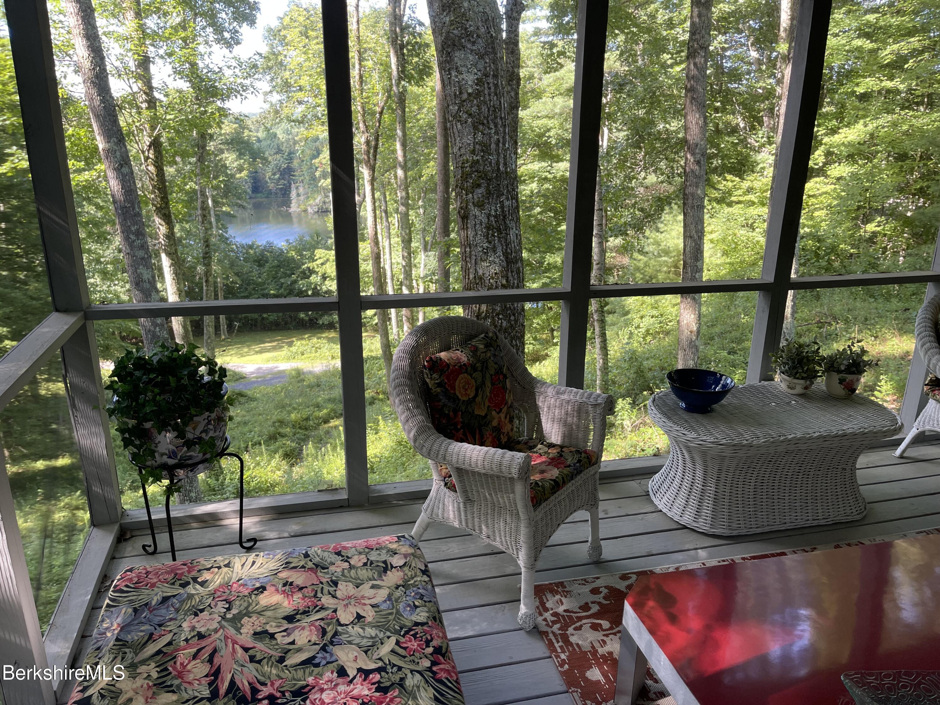 a view of a porch with furniture and floor to ceiling window