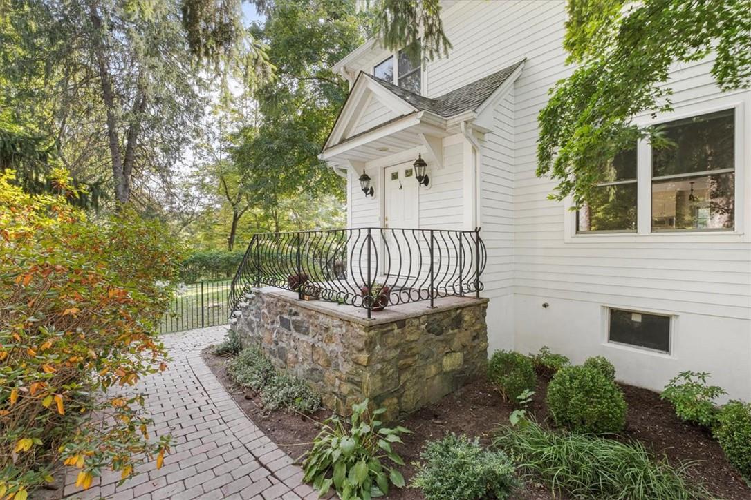 Front entrance with a brick walkway