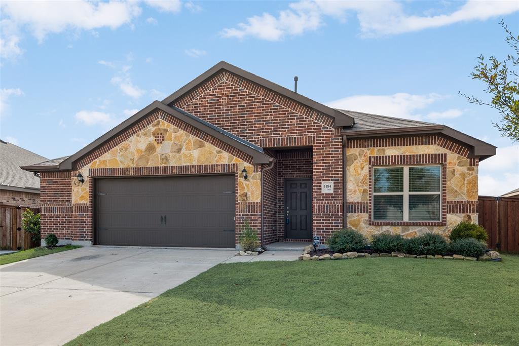 a view of a house with a yard and garage