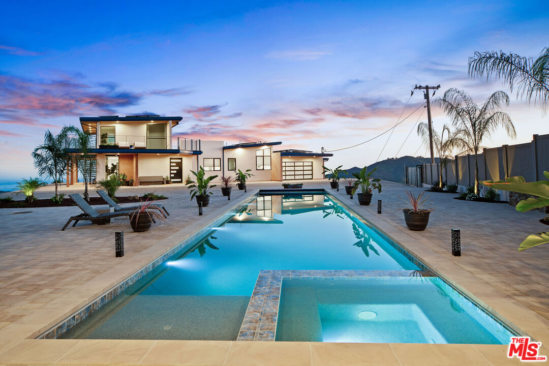 a view of a swimming pool with outdoor seating