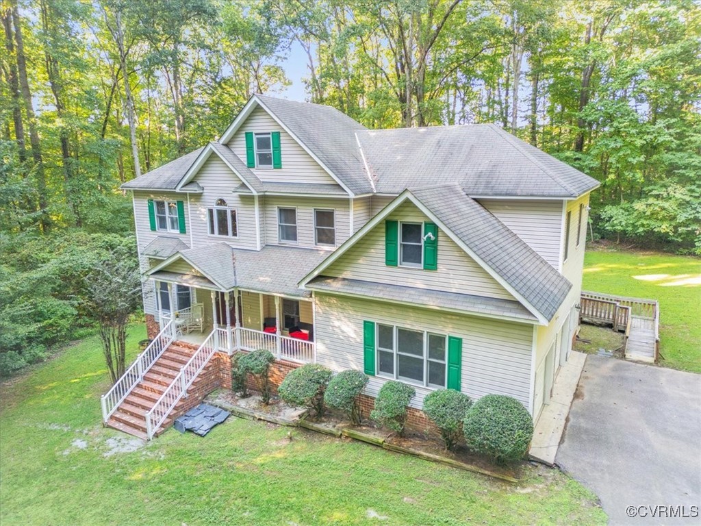 View of front of home featuring covered porch, a g