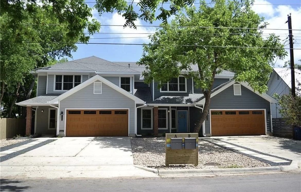 a front view of a house with a garden