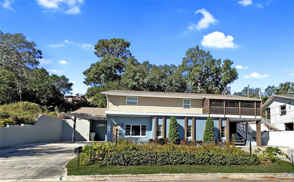 a front view of a house with a yard and a garden