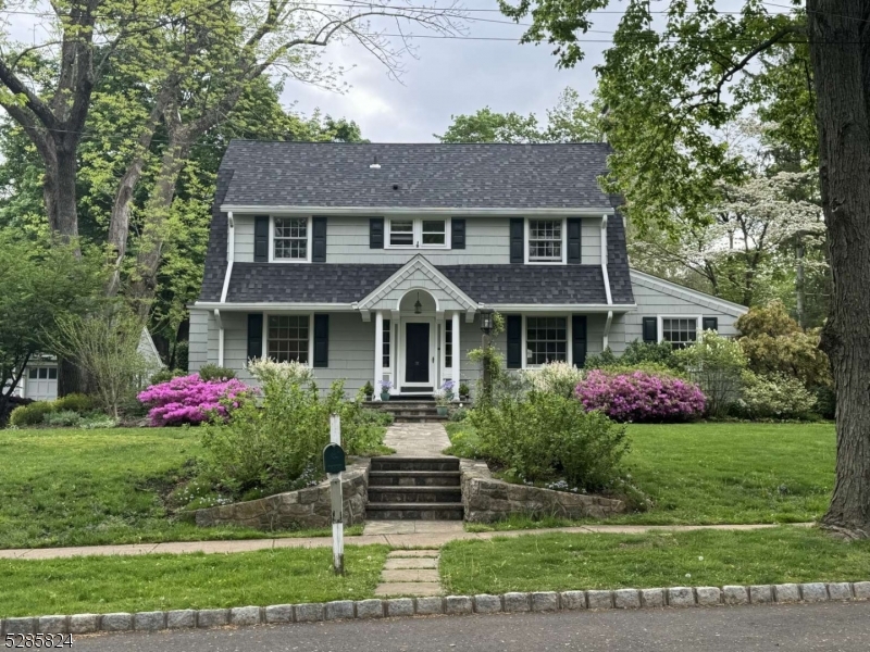 a front view of a house with a garden