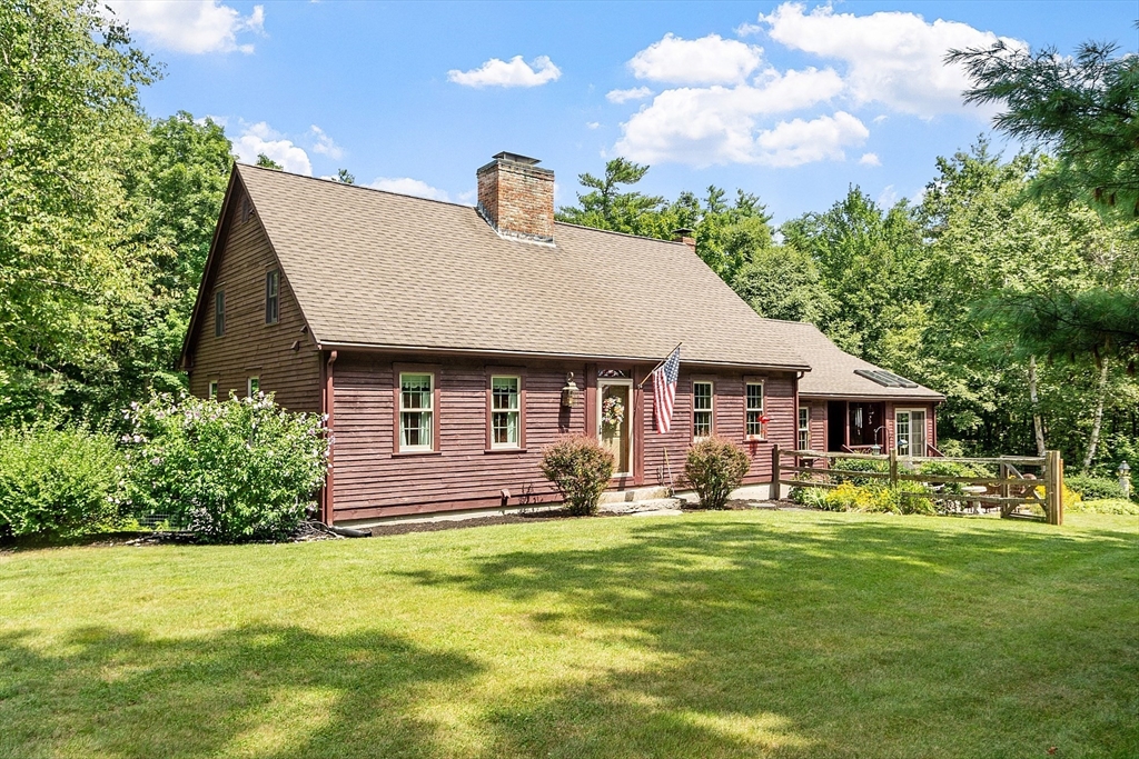 a front view of house with yard and trees