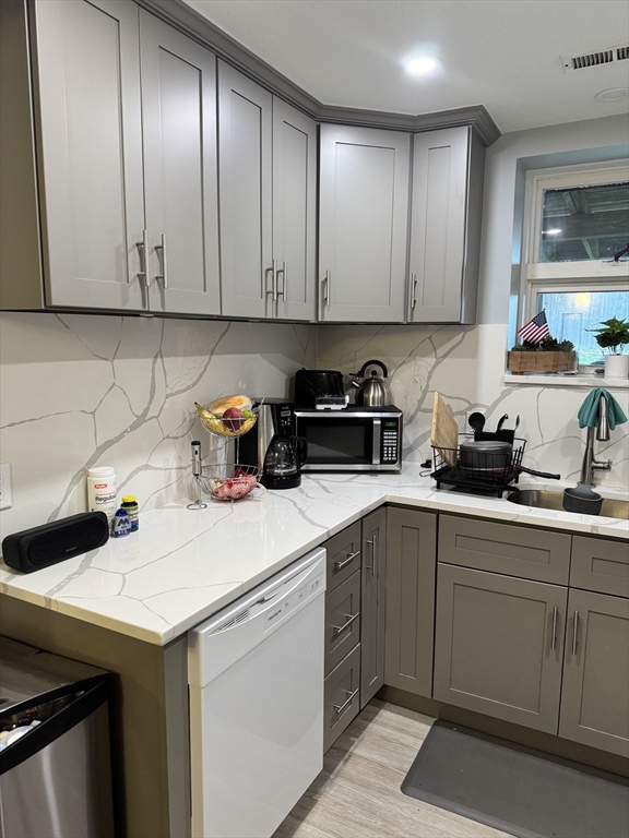 a kitchen with a sink cabinets and stainless steel appliances