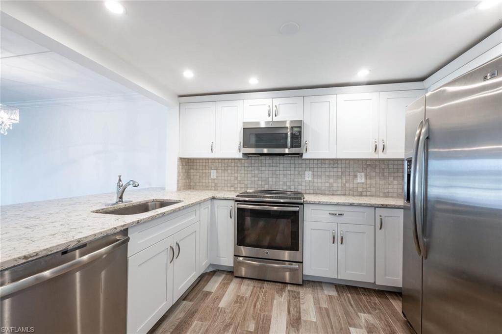 a kitchen with a sink stove and refrigerator