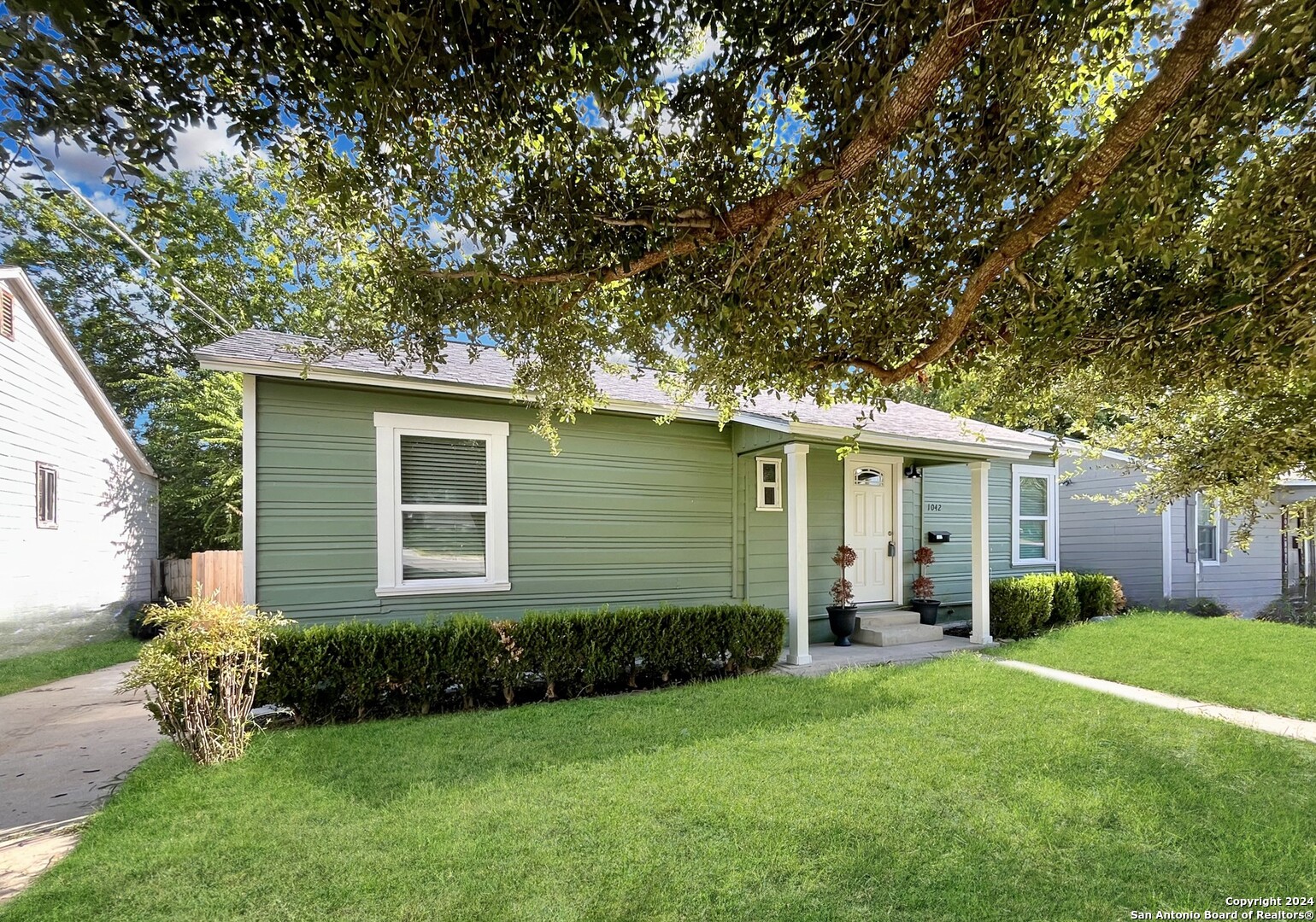 a front view of house with yard and green space