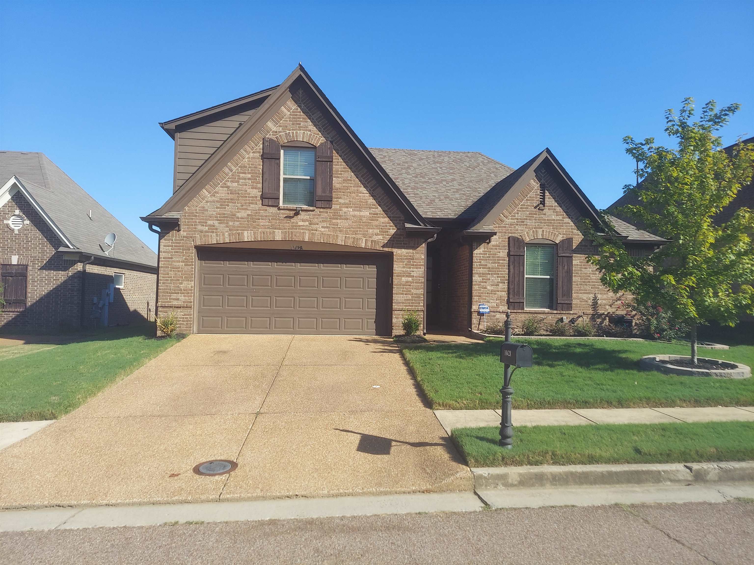 View of front of house with a garage and a front lawn