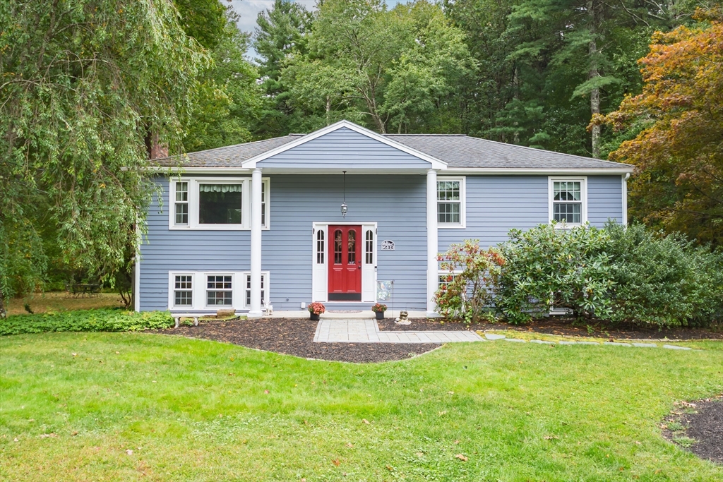 a front view of house with yard and green space