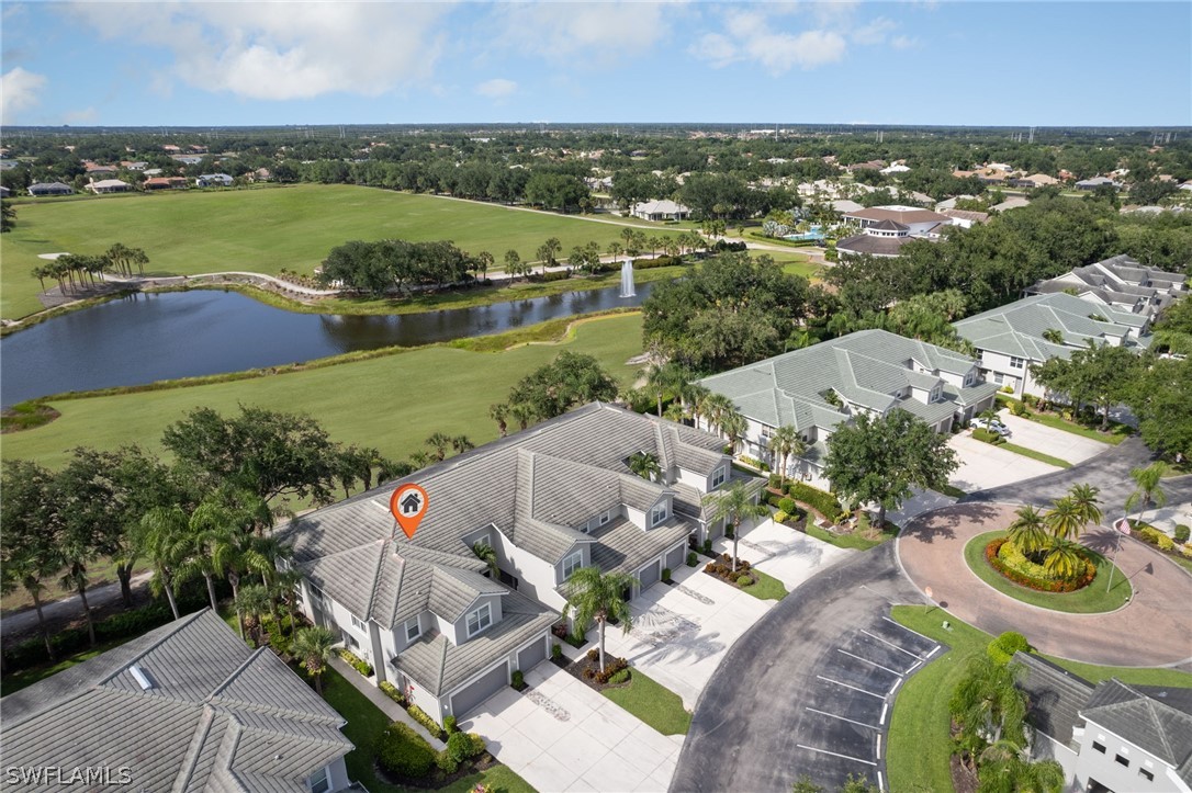 an aerial view of residential houses with outdoor space and river