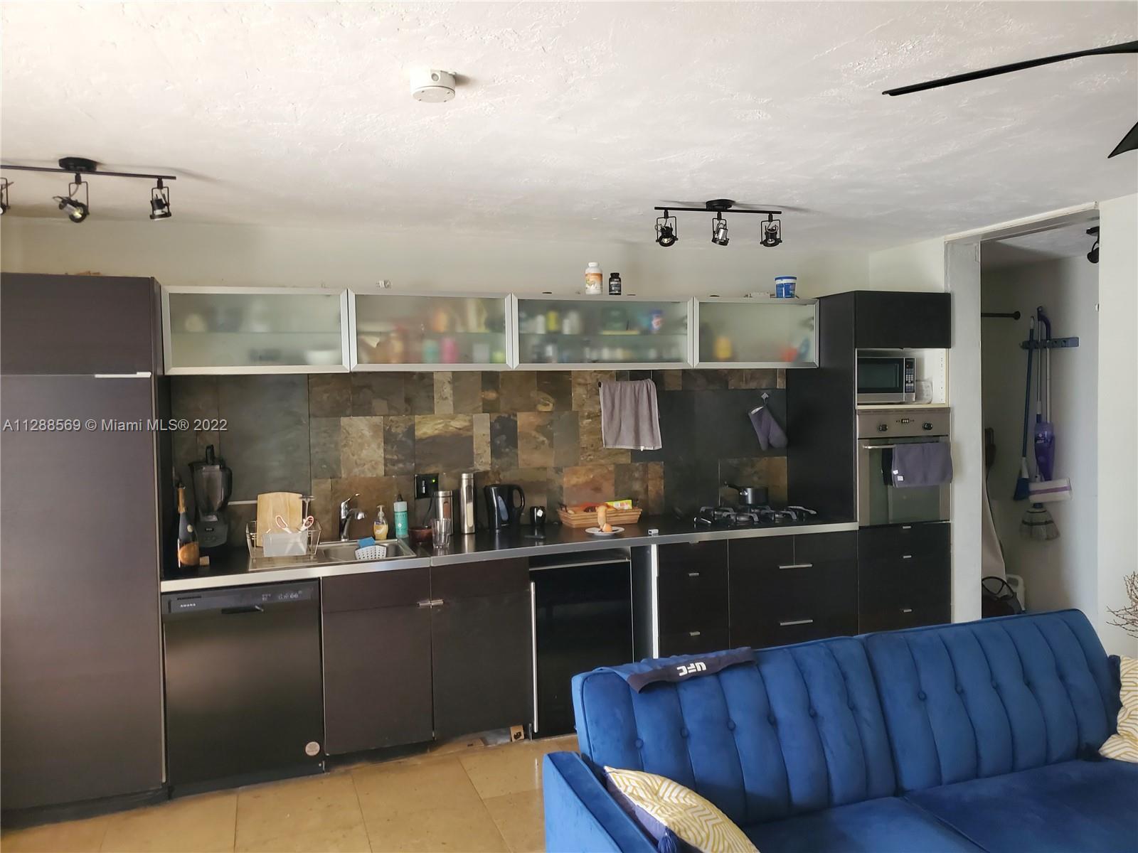 a kitchen with a refrigerator and cabinets