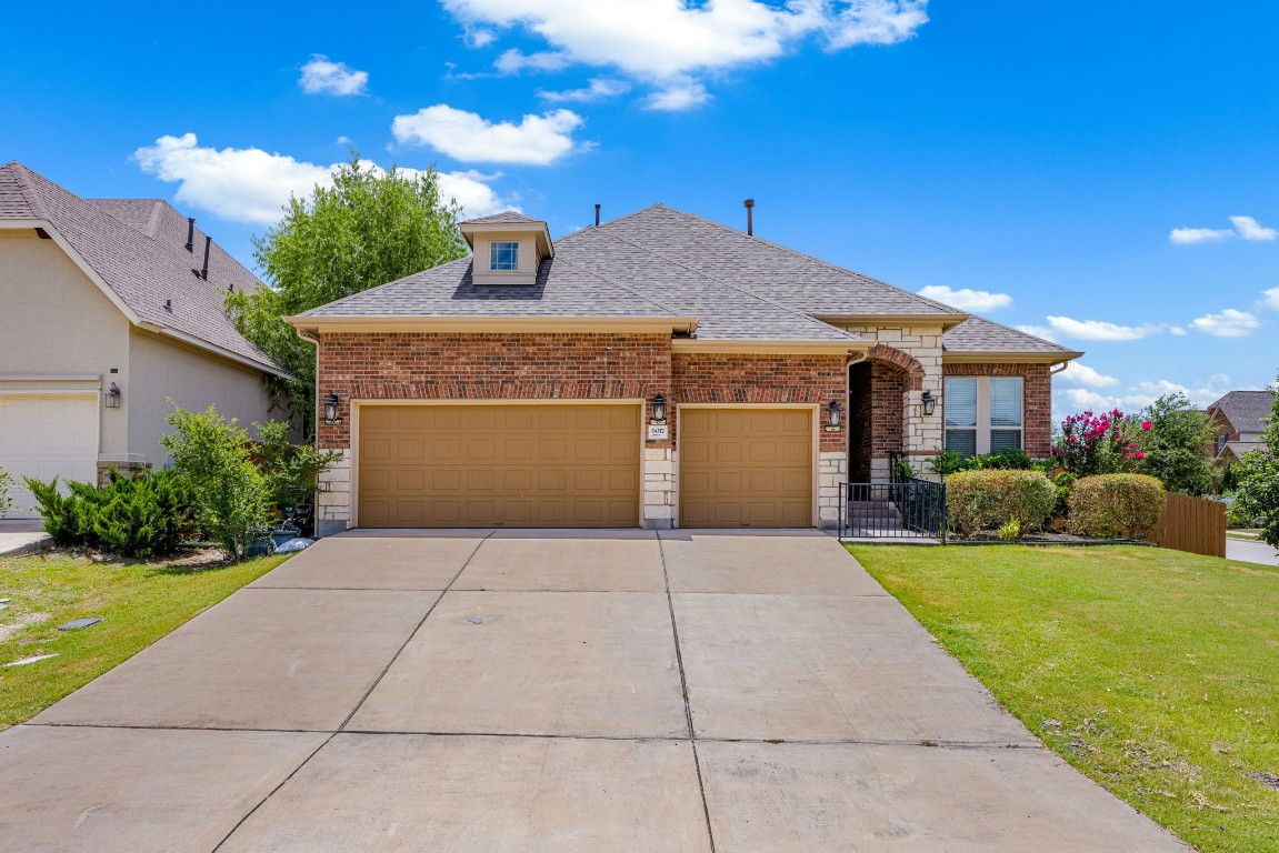 a front view of a house with a garden