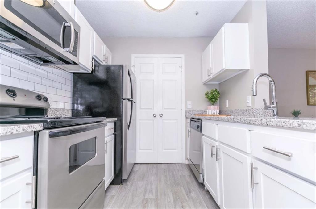 a kitchen with stainless steel appliances granite countertop a stove and a refrigerator