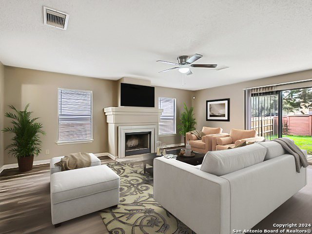 a living room with furniture a fireplace and a flat screen tv