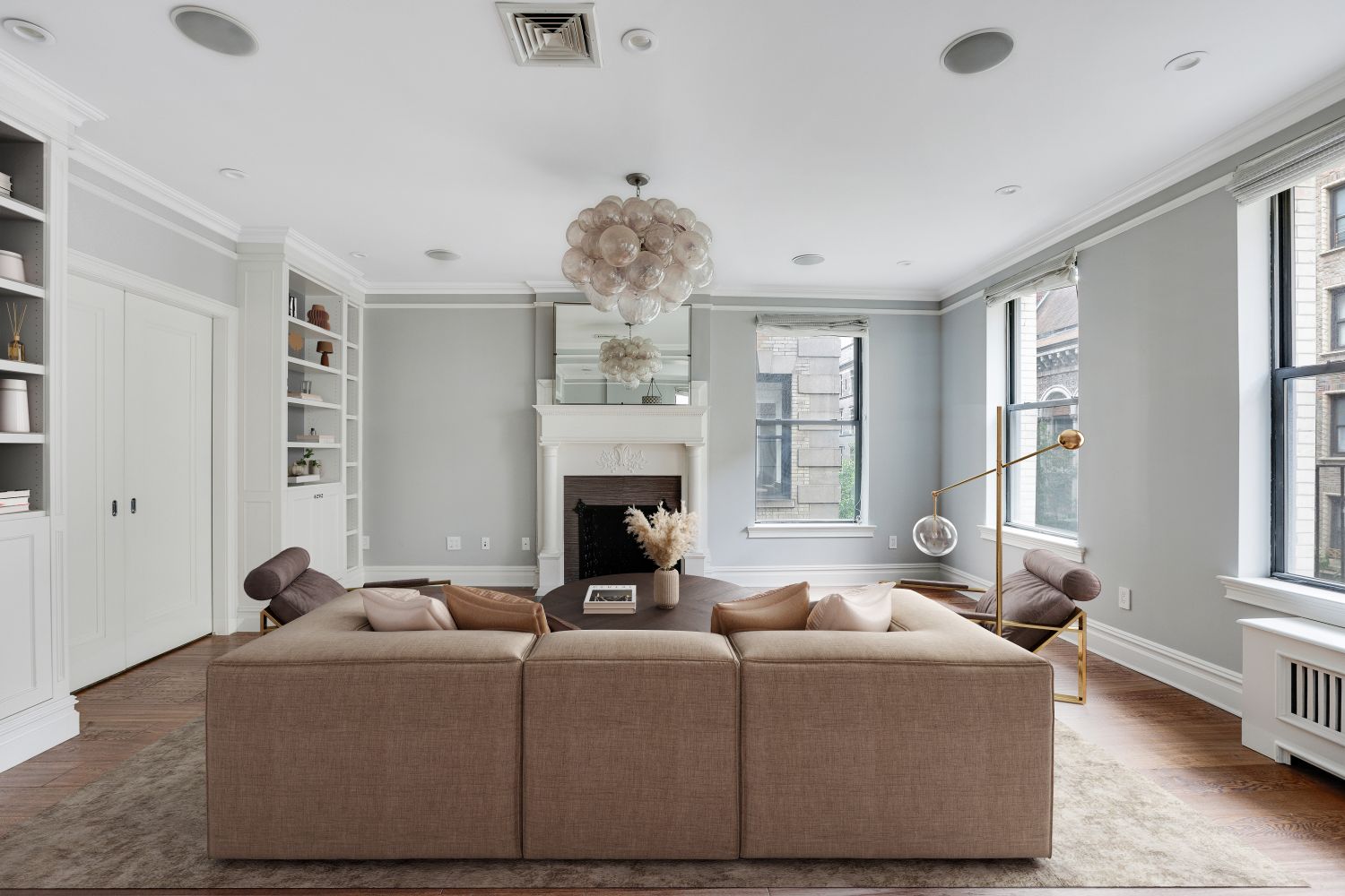 a living room with furniture a fireplace and a large window