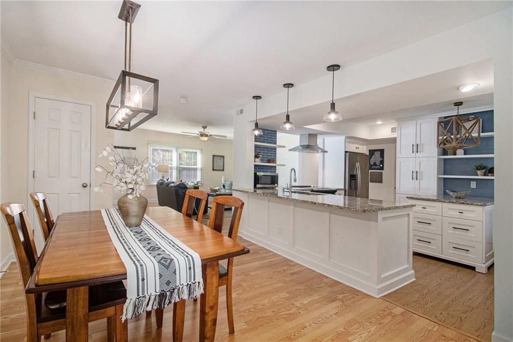 a large kitchen with a table and chairs