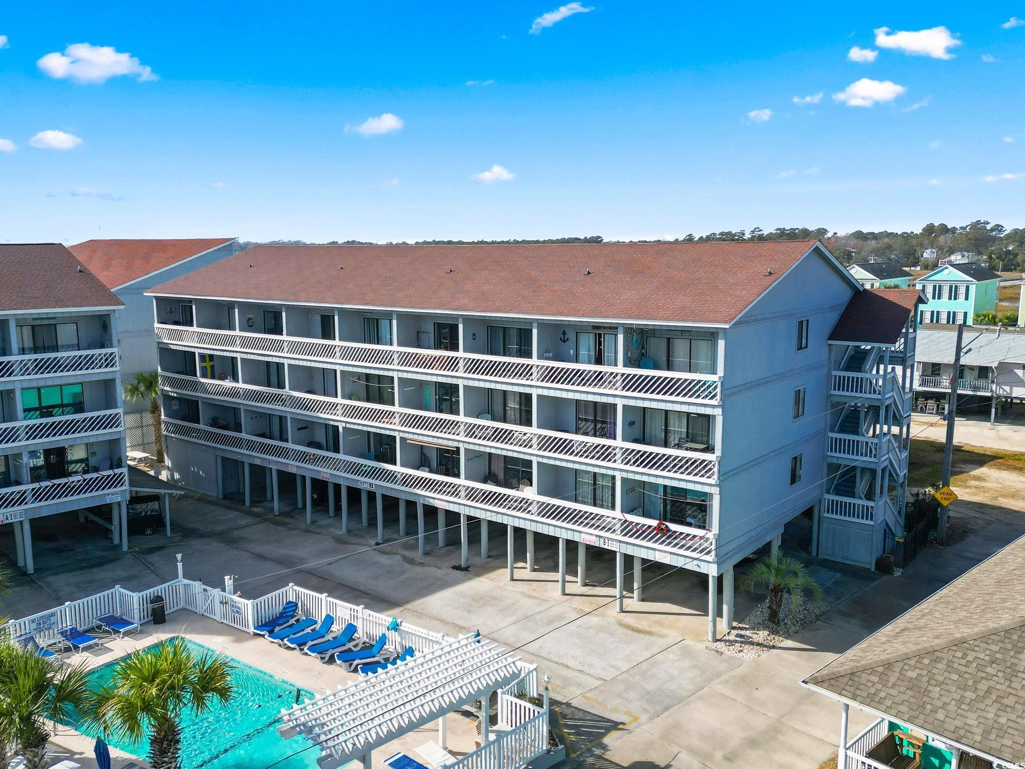 View of building exterior with a community pool