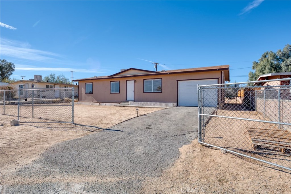 a view of a house with a wooden fence