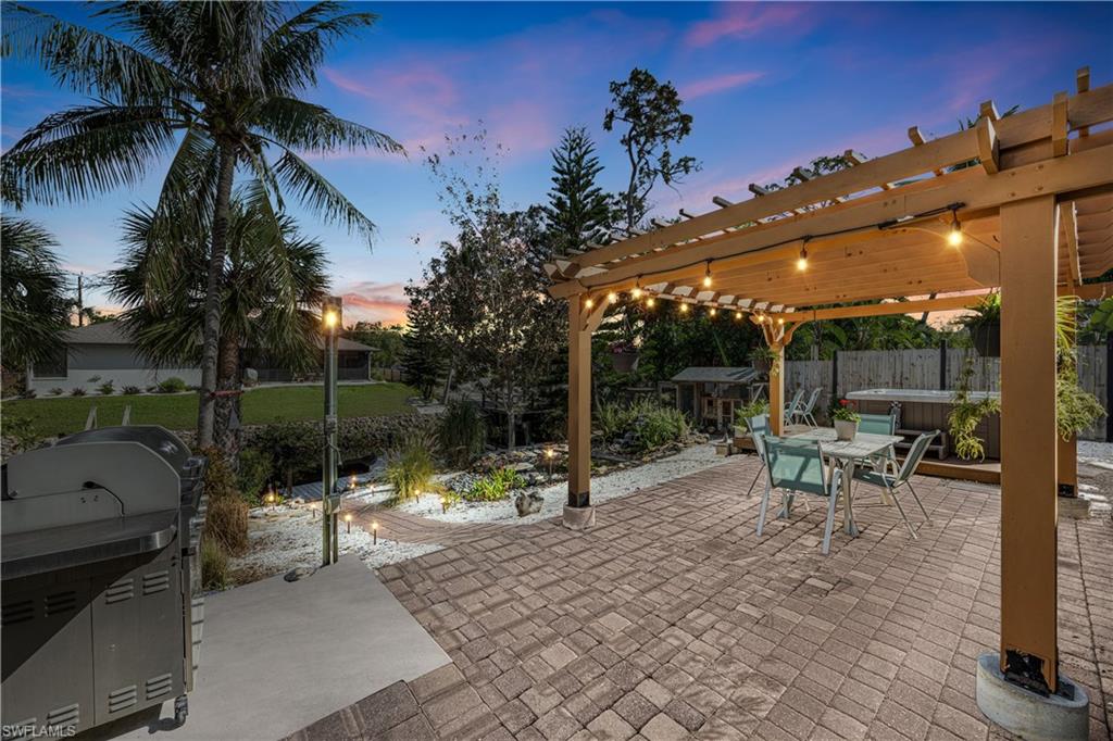 a view of a patio with a table and chairs under an umbrella