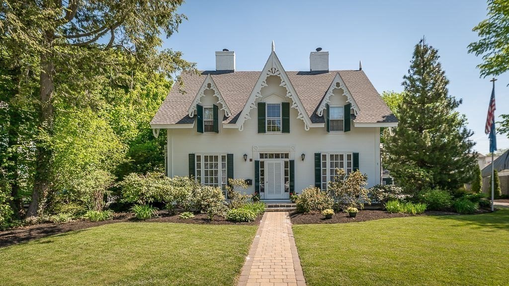 a front view of house with yard and green space