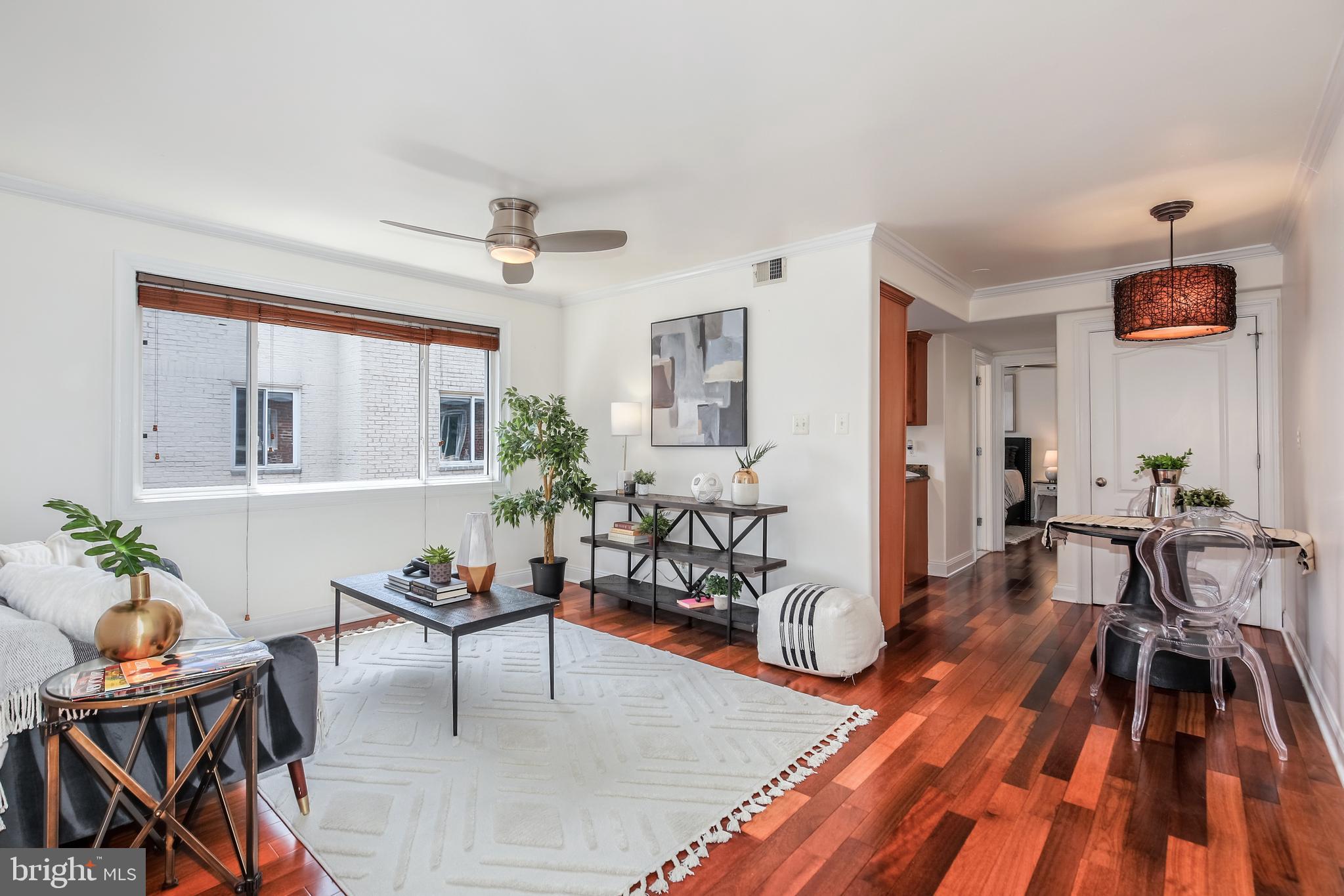 a living room with furniture and wooden floor