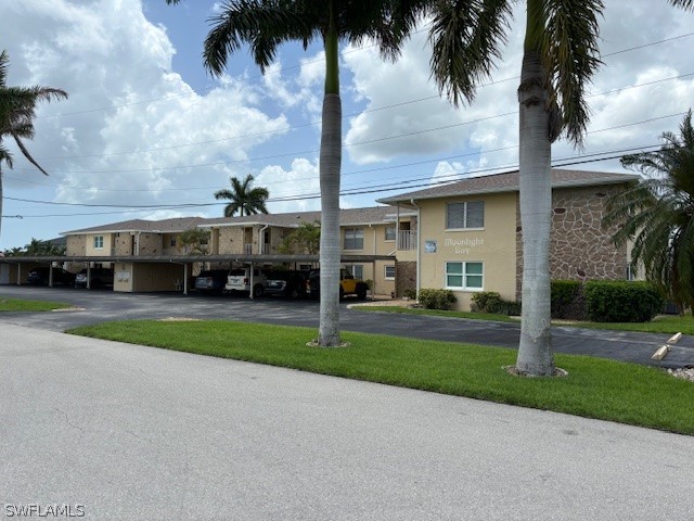 a front view of house with yard and green space