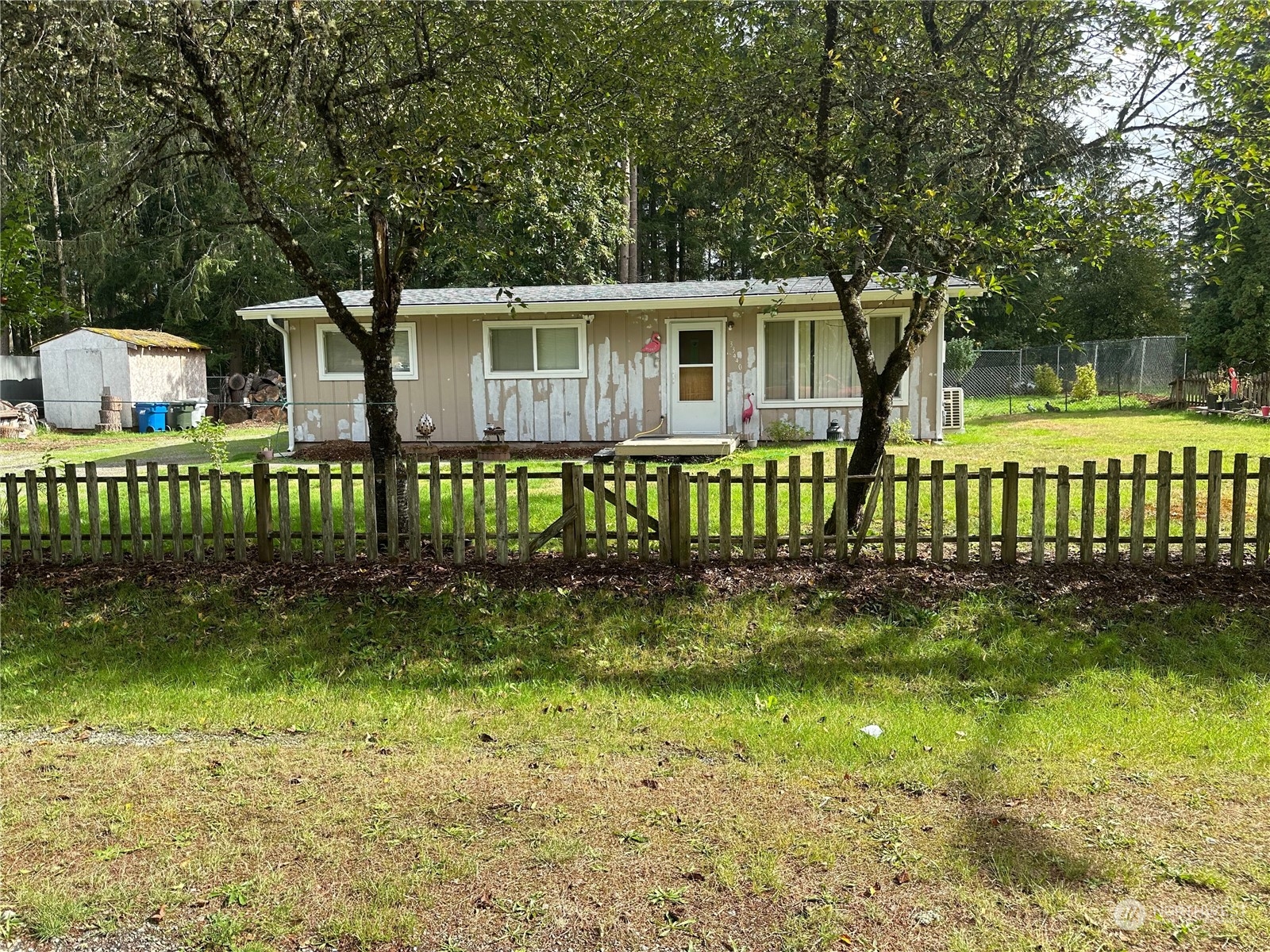 a view of a house with a yard and a garden