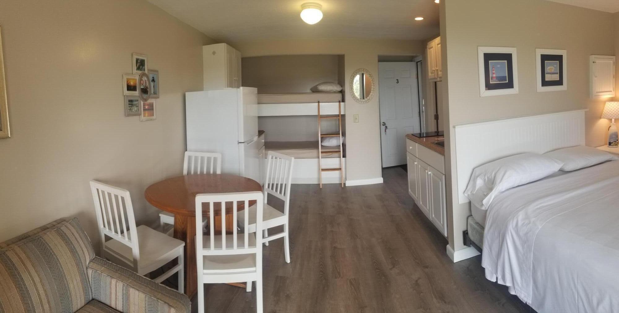 a view of a hallway with furniture and wooden floor