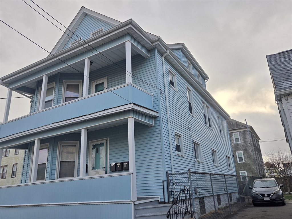 a view of building with car parked