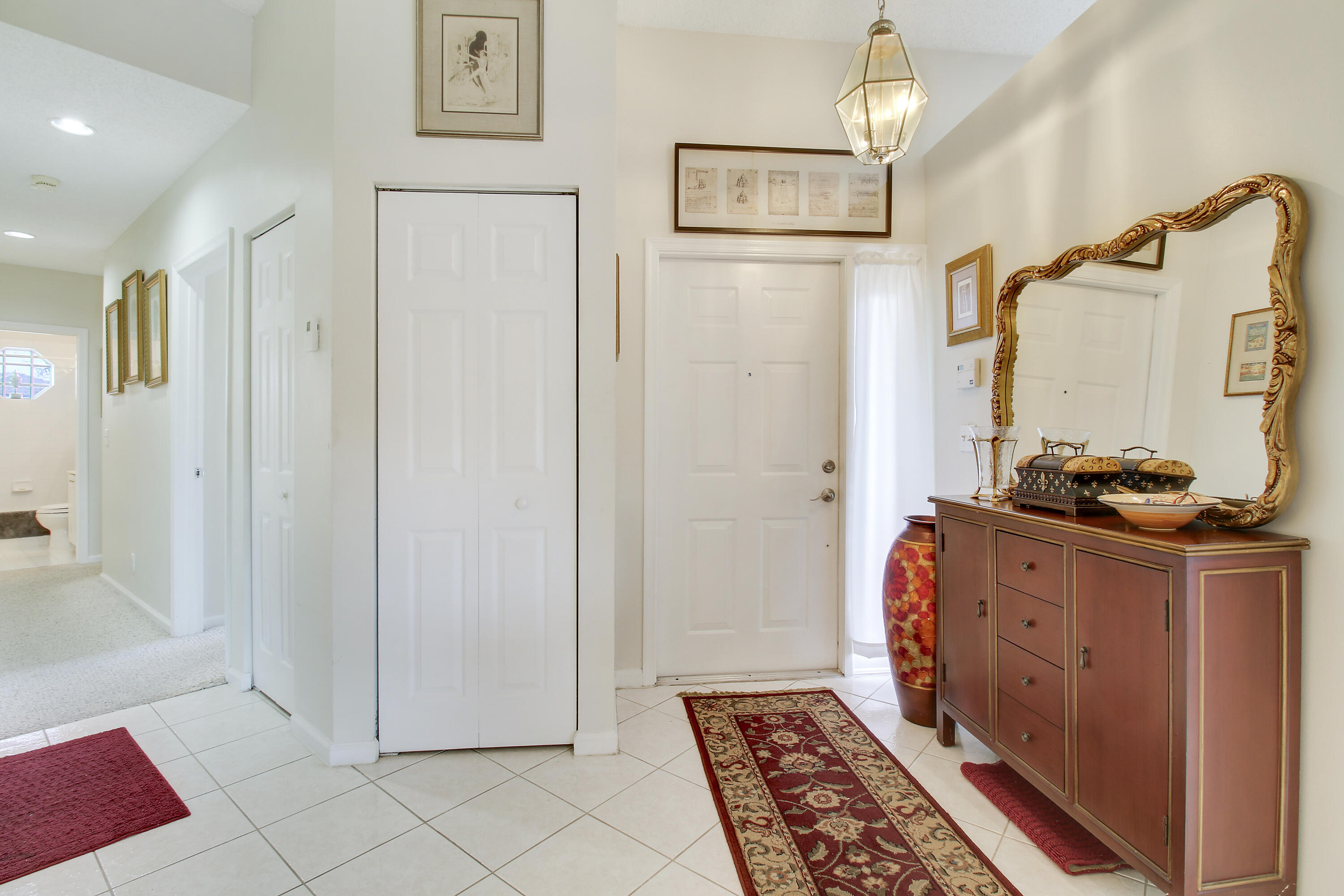 a bedroom with furniture and a mirror