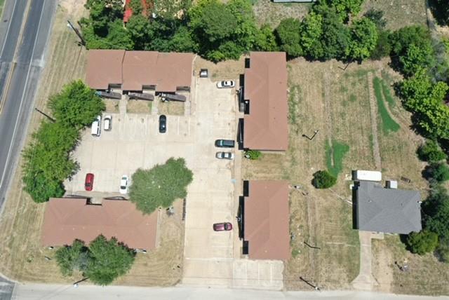 an aerial view of residential houses with outdoor space and parking