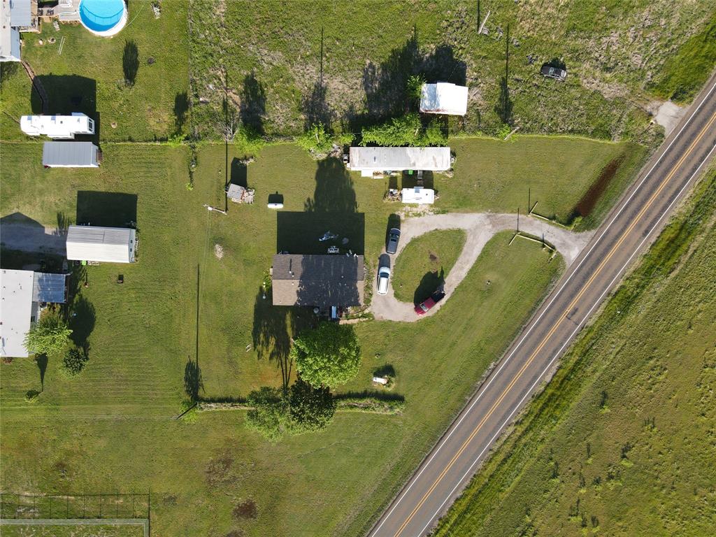 an aerial view of a residential houses with outdoor space and swimming pool