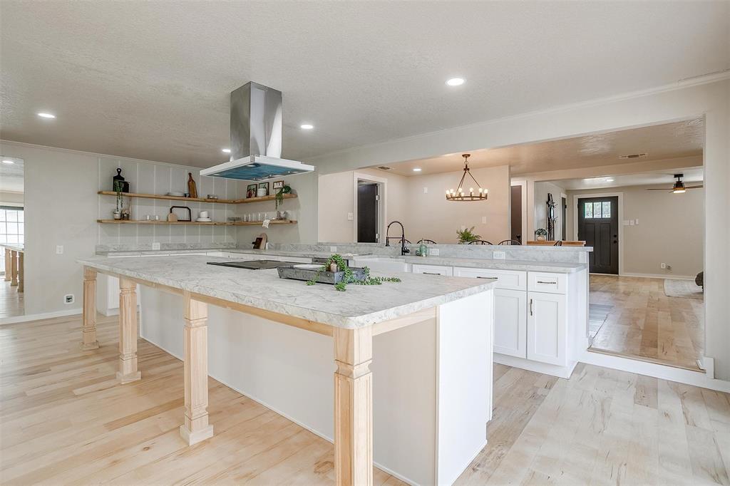 a large kitchen with a sink and cabinets