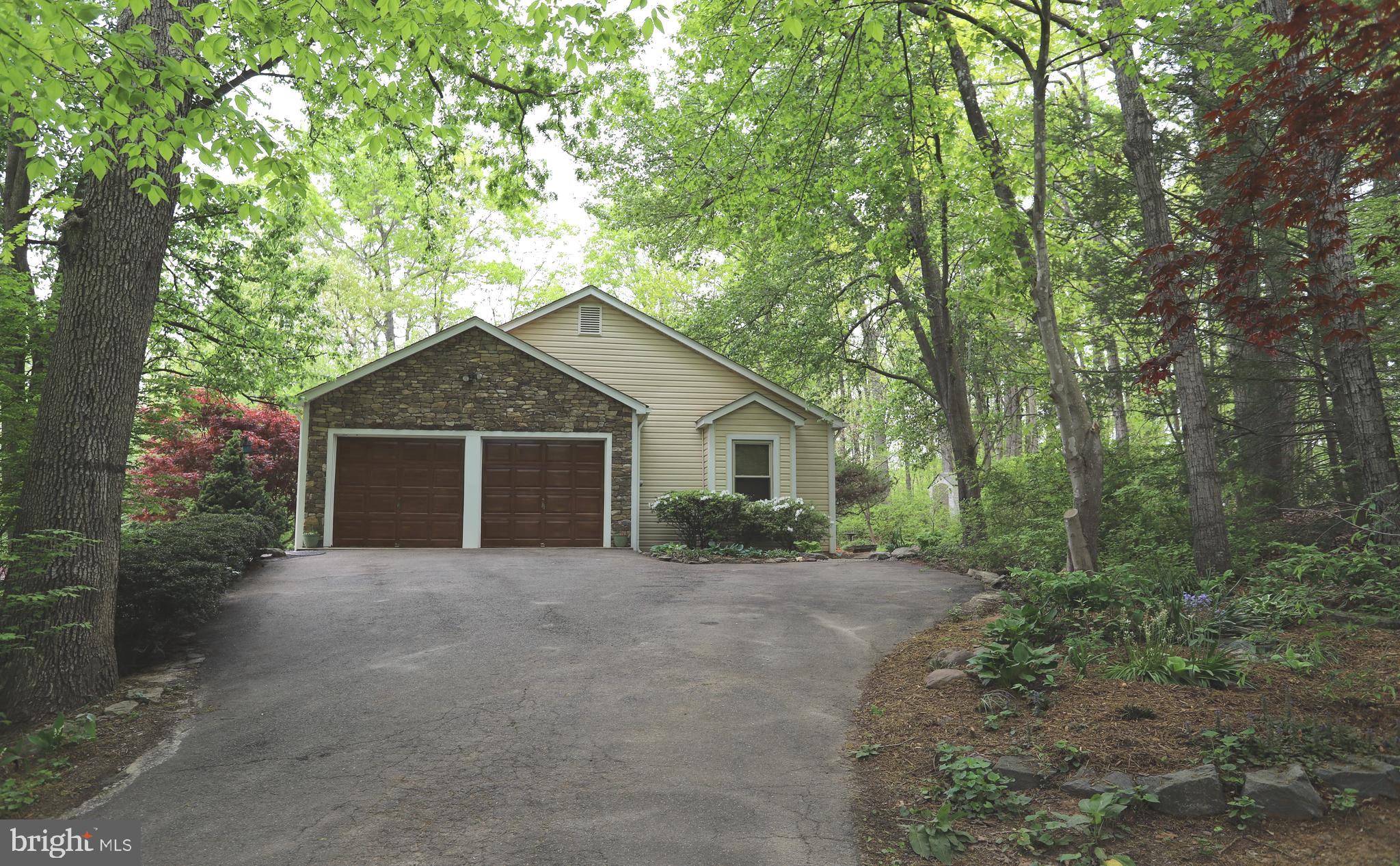 a view of a house with large trees