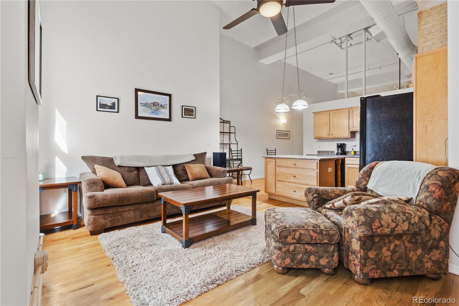 a living room with furniture and kitchen view