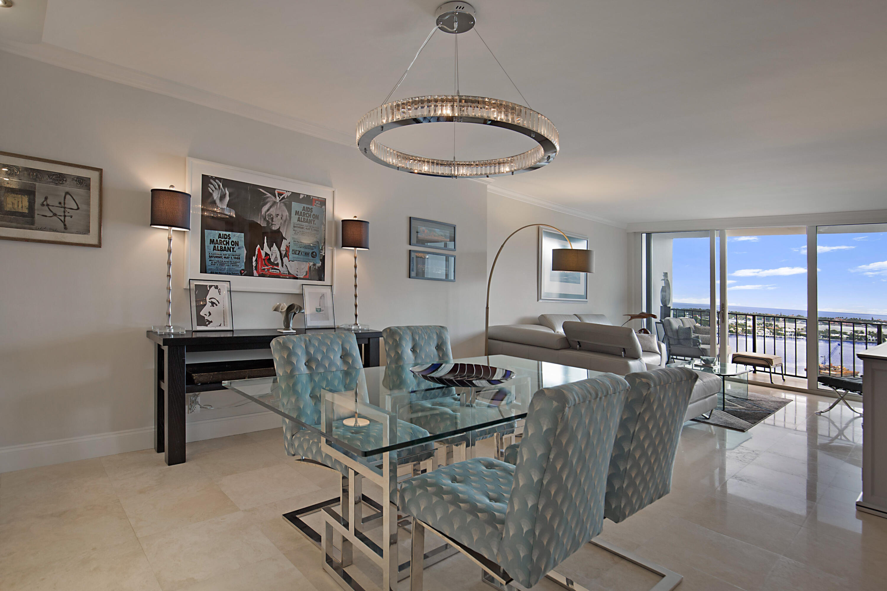 a dining room with furniture a rug and a large window