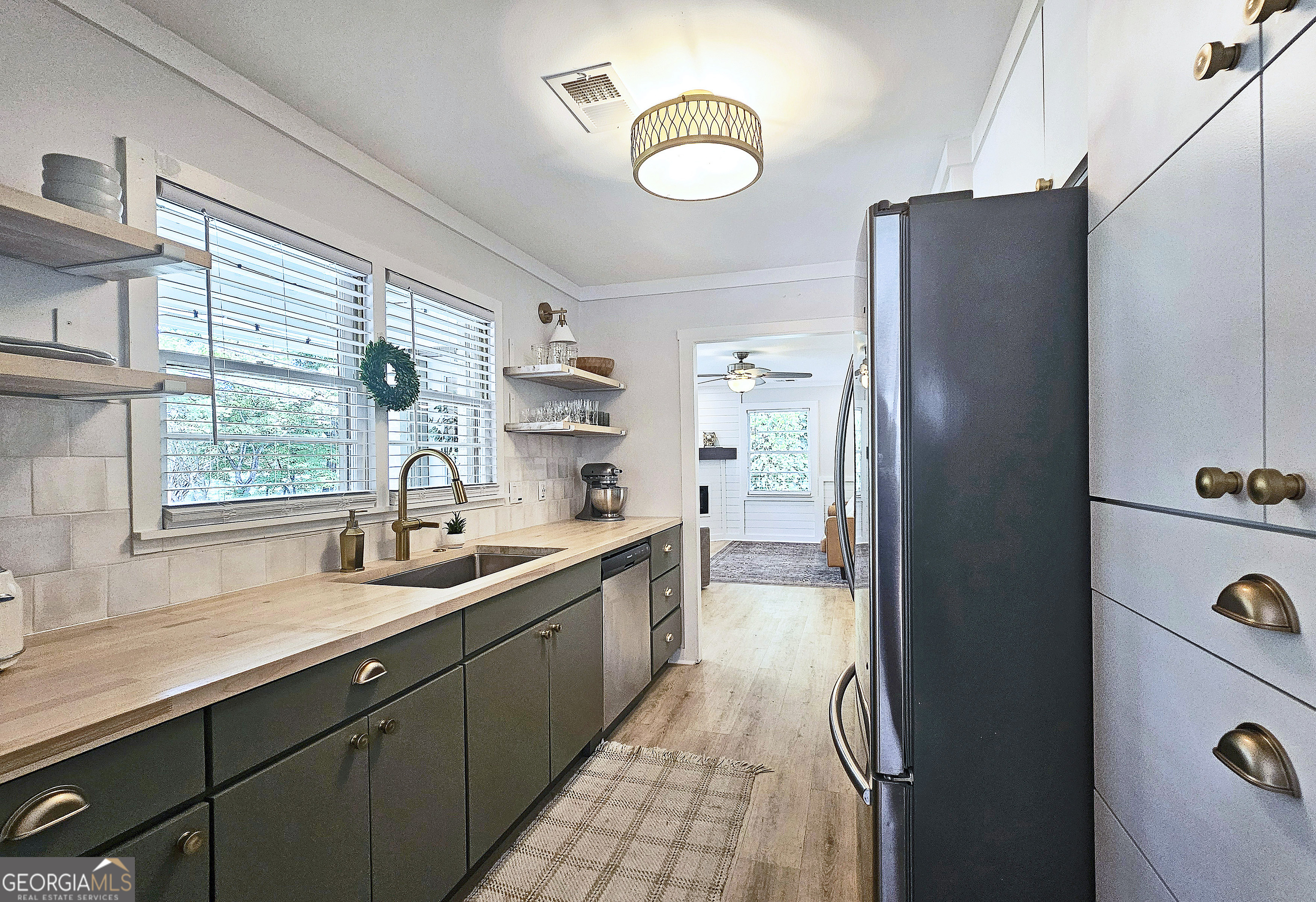 a kitchen with stainless steel appliances granite countertop a refrigerator and a sink