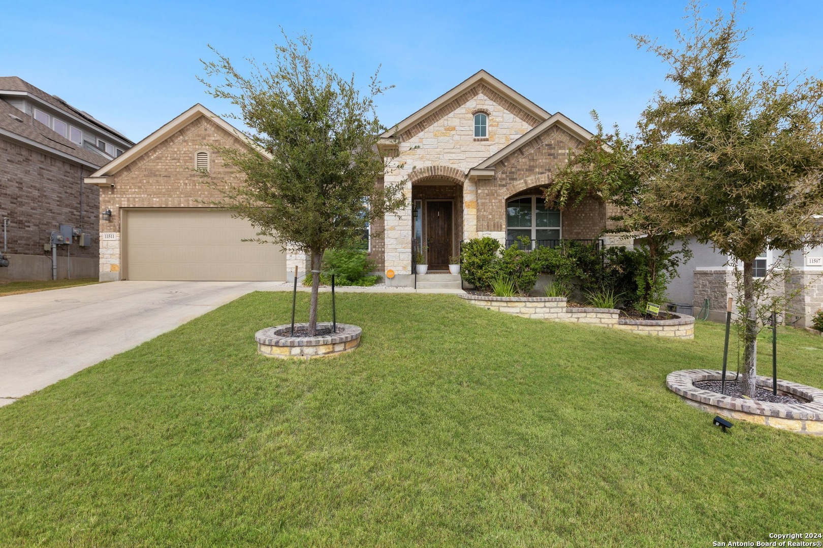 a front view of a house with a yard and garage