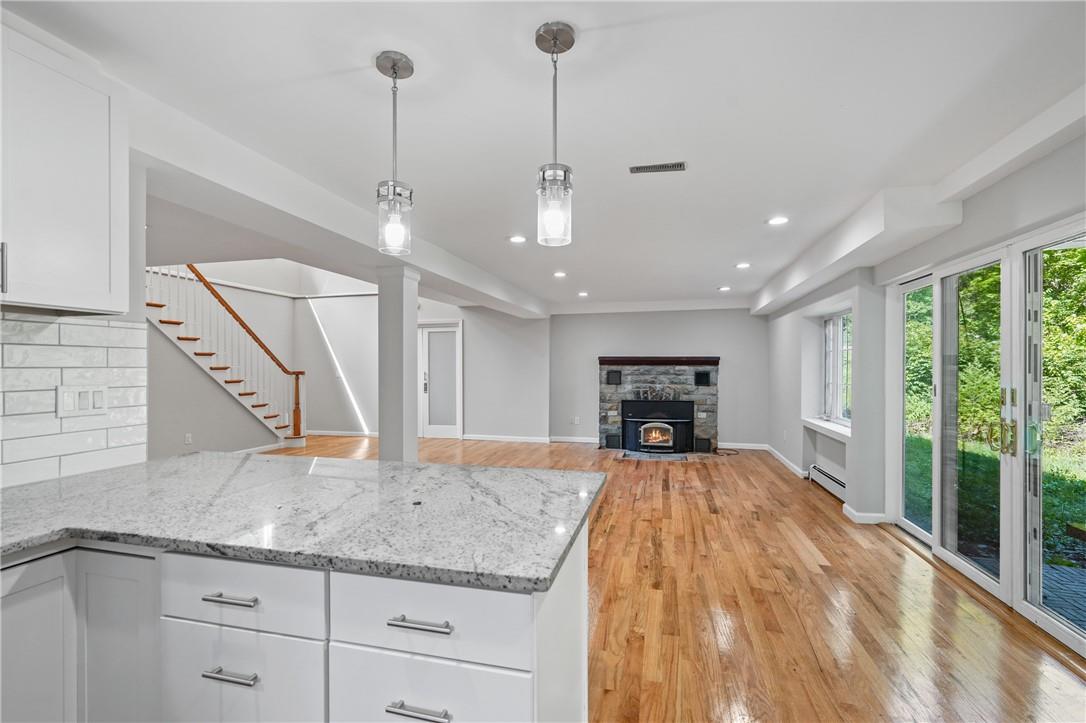 a view of a kitchen with a sink and wooden floor