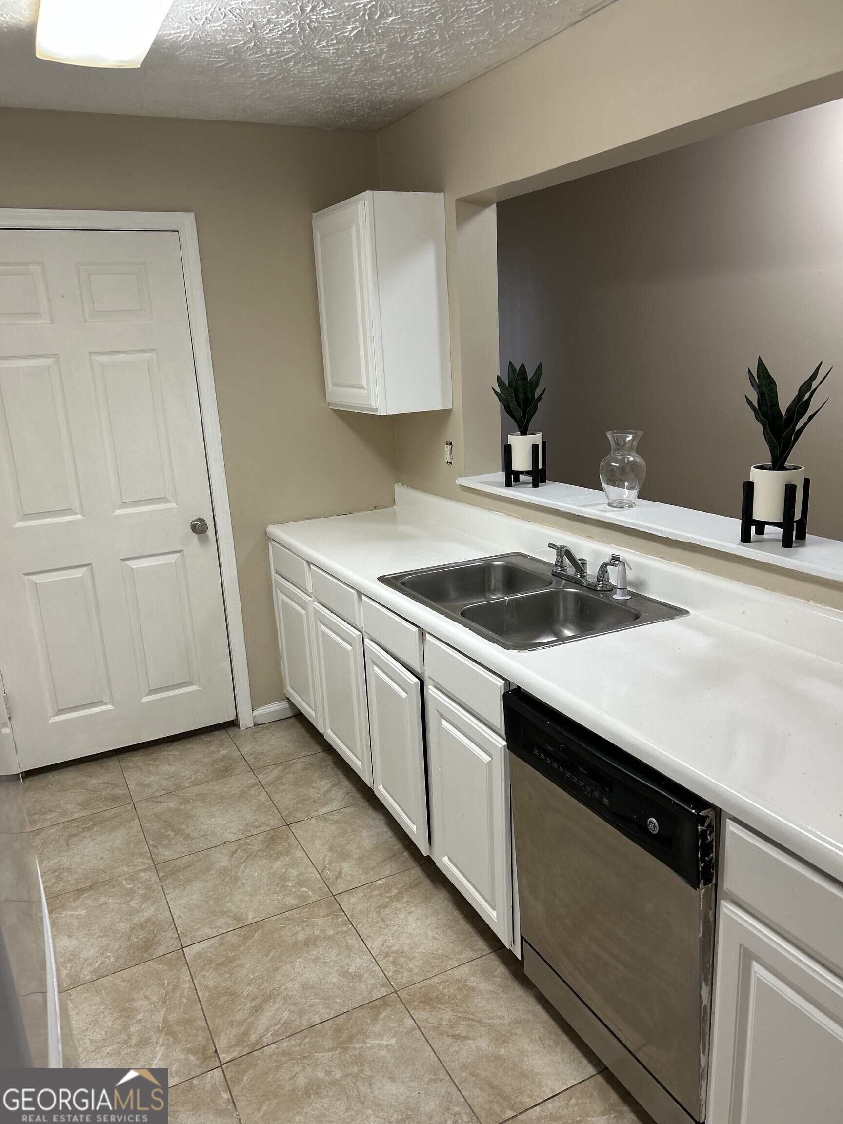 a kitchen with a sink and cabinets