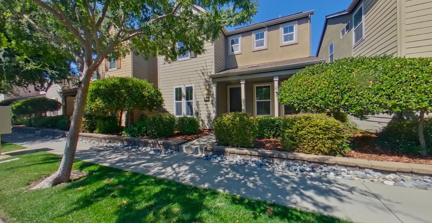 a view of a house with a yard and plants