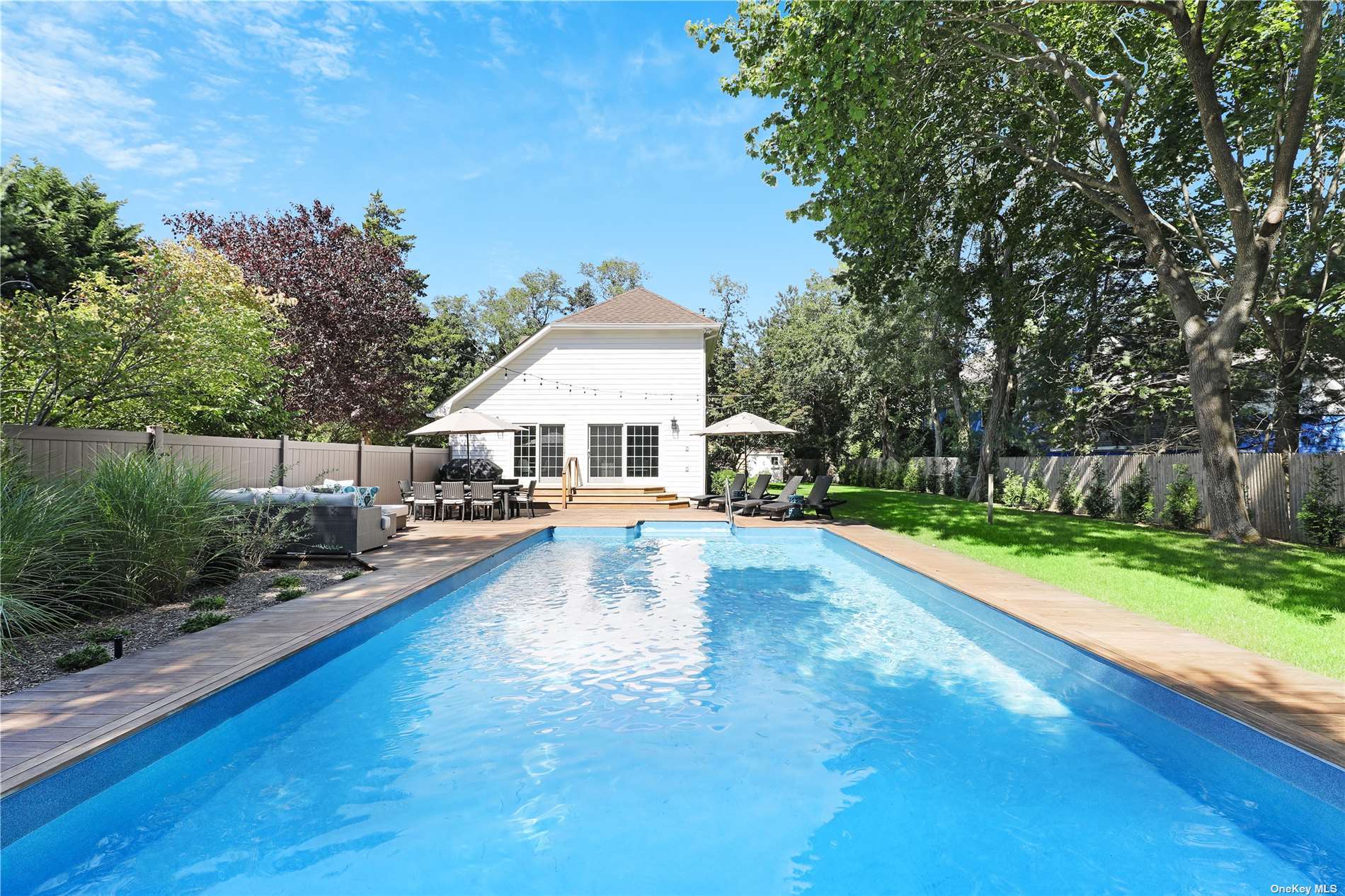 a view of a house with swimming pool and sitting area