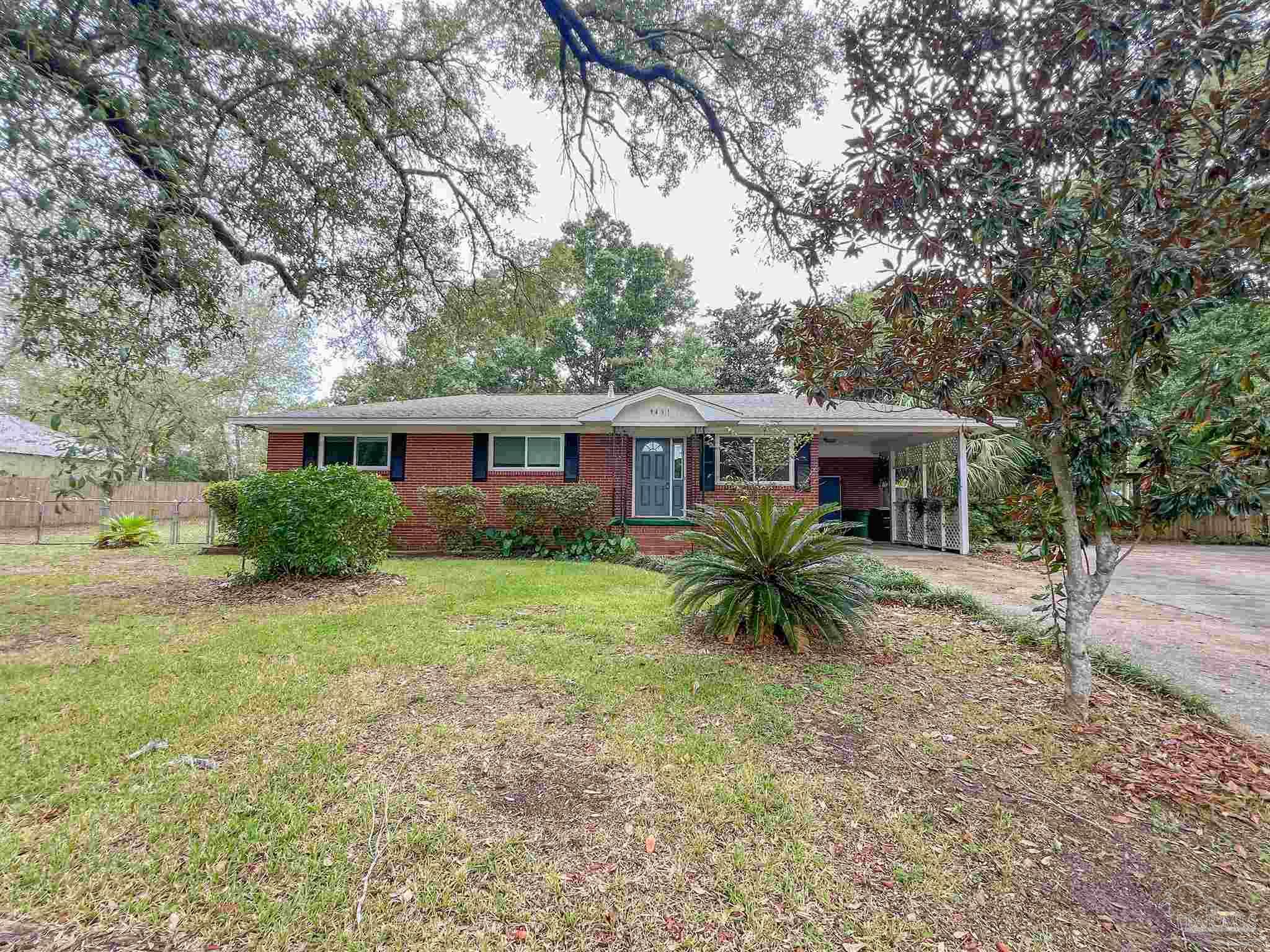 a front view of house with a garden