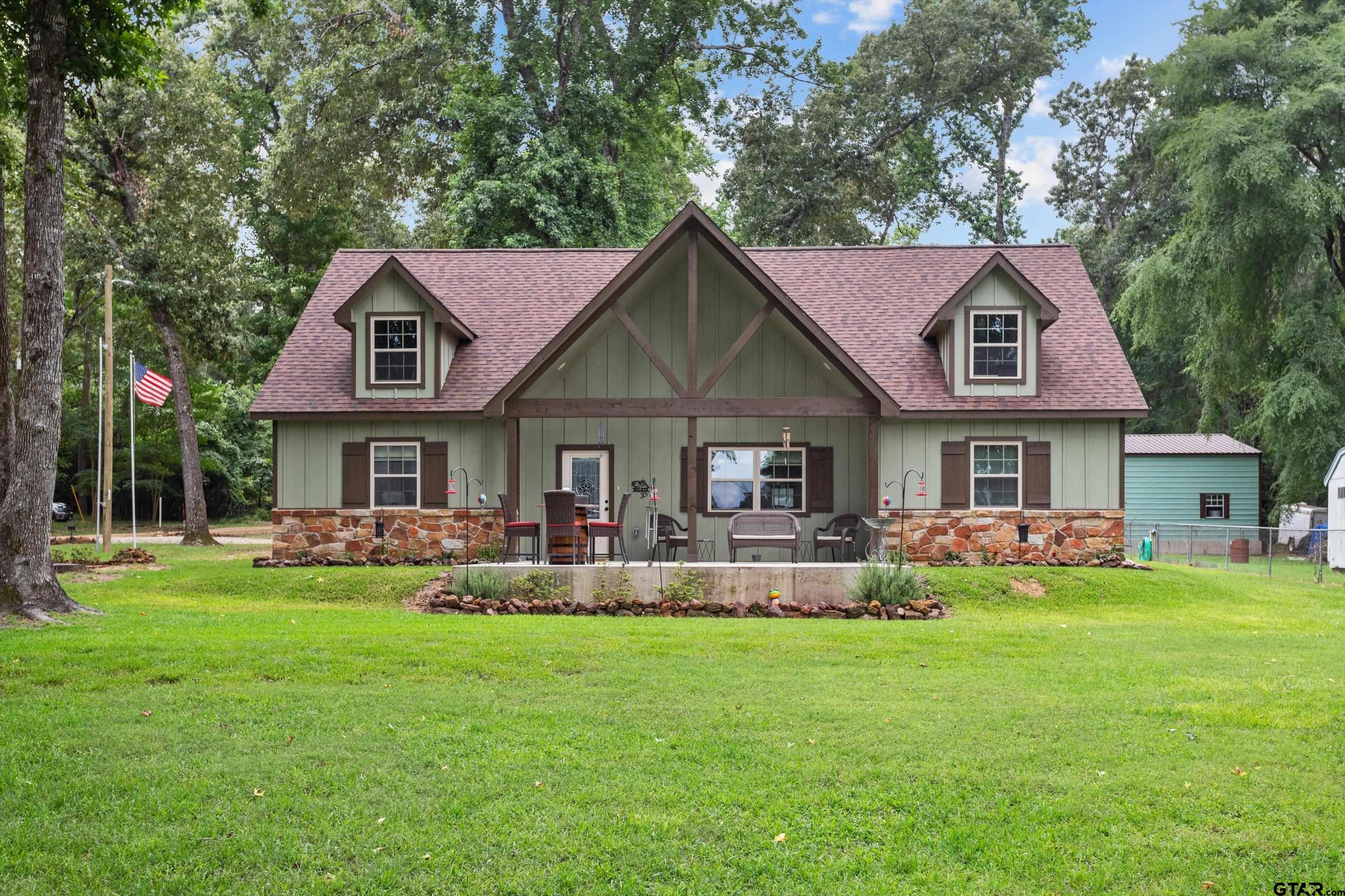 a front view of house with yard and green space