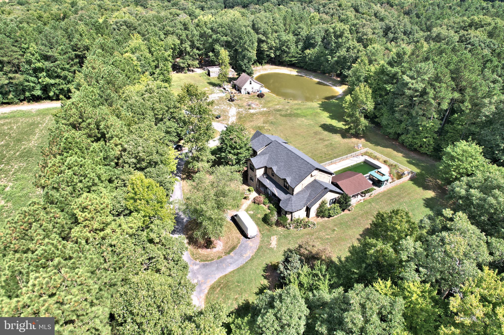 an aerial view of a house with a yard