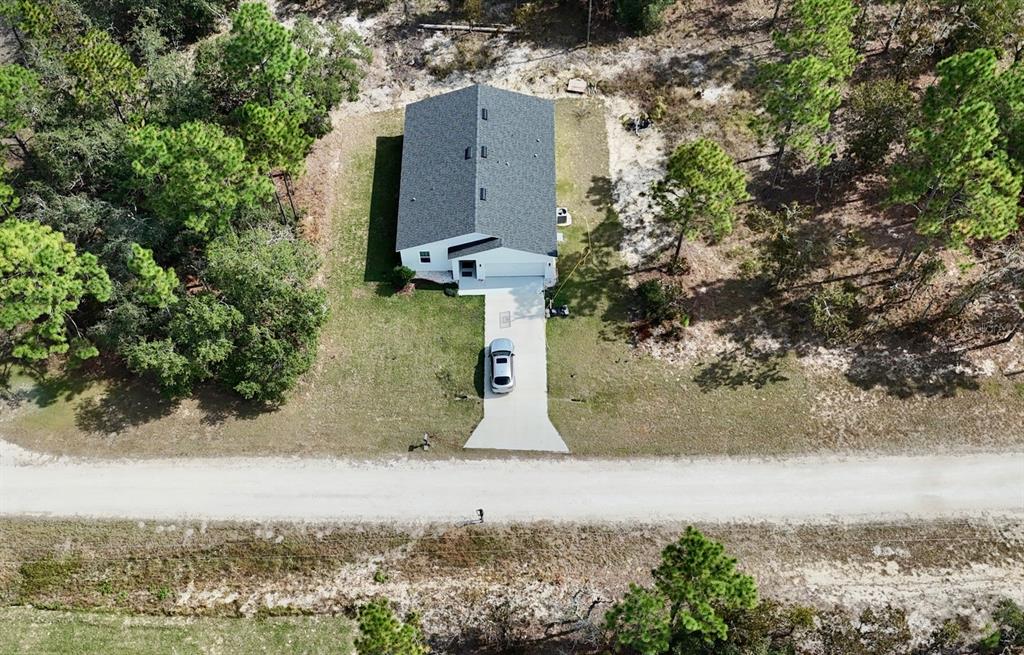 an aerial view of a house with yard and garage