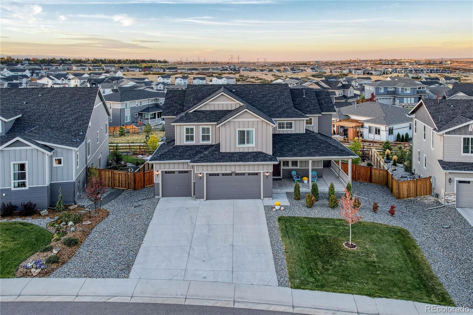 an aerial view of a house with a garden and lake view