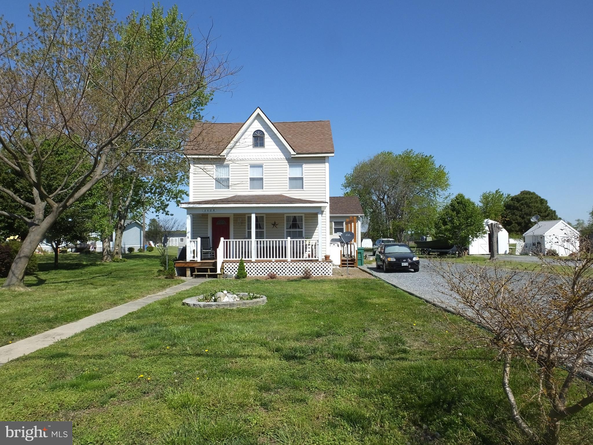 a view of a house with backyard porch and sitting area