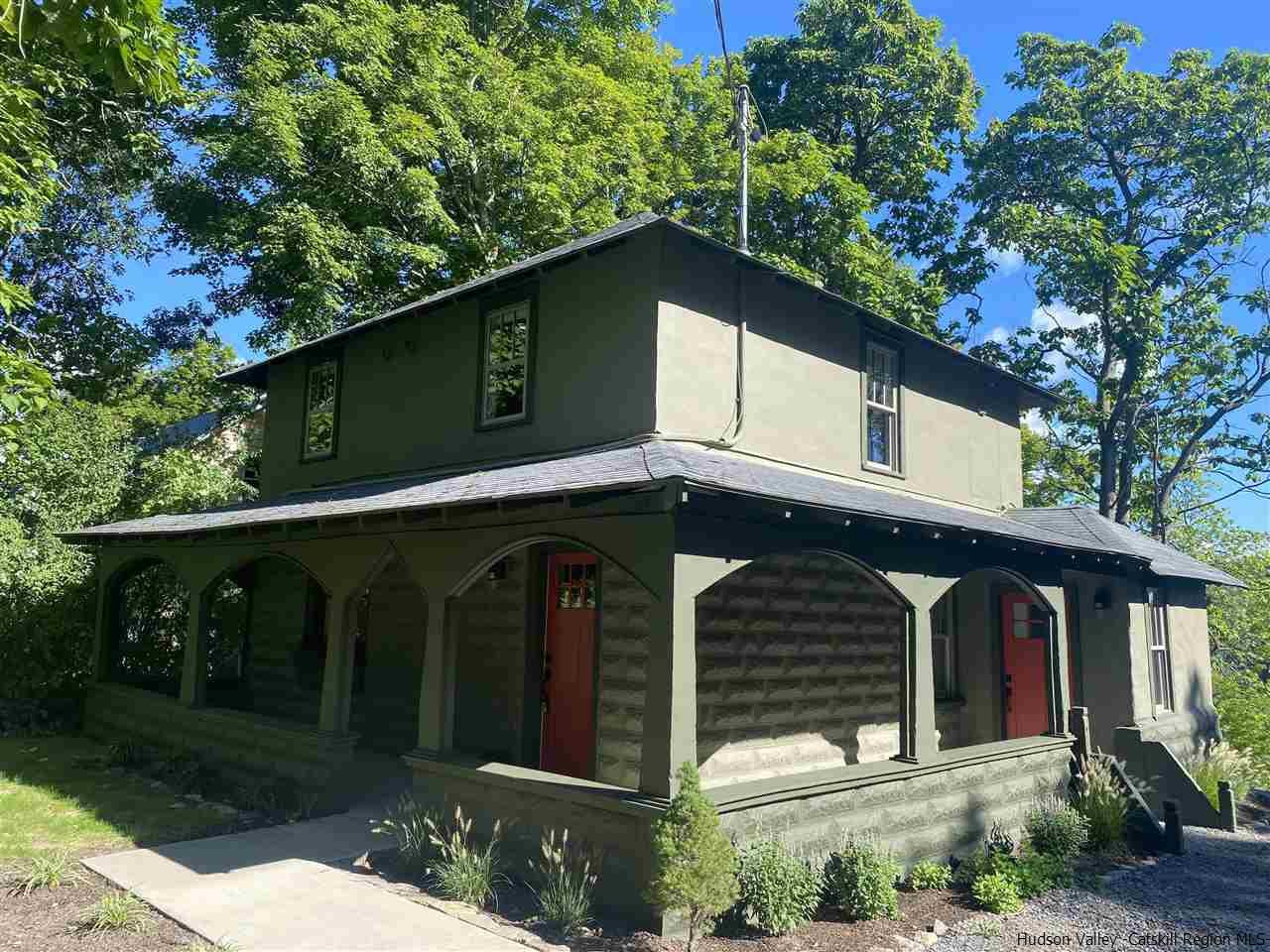 a front view of a house with plants